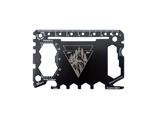 A black multi-tool card with engraved silver markings, including a ruler, measurements, and a triangular forest logo, shown on a plain white background.